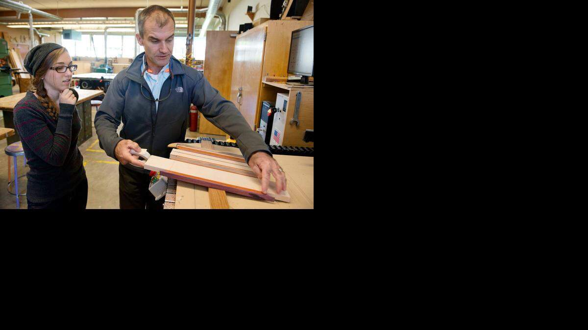 
Teacher and inventor Jonathan Schwartz helps Renae D’Amour with her cutting board project in her computer integrated manufacturing class at Colfax High School in Colfax. Swartz doesn’t expect his students to have all the answers, but he does expect them to use every tool in their workshop to find them. Schwartz’s classroom and shop is a playground for tinkerers, inventors, innovators. The classroom has 18 computers with software to do computer-aided design and manufacturing, plus a 3-D printer.
