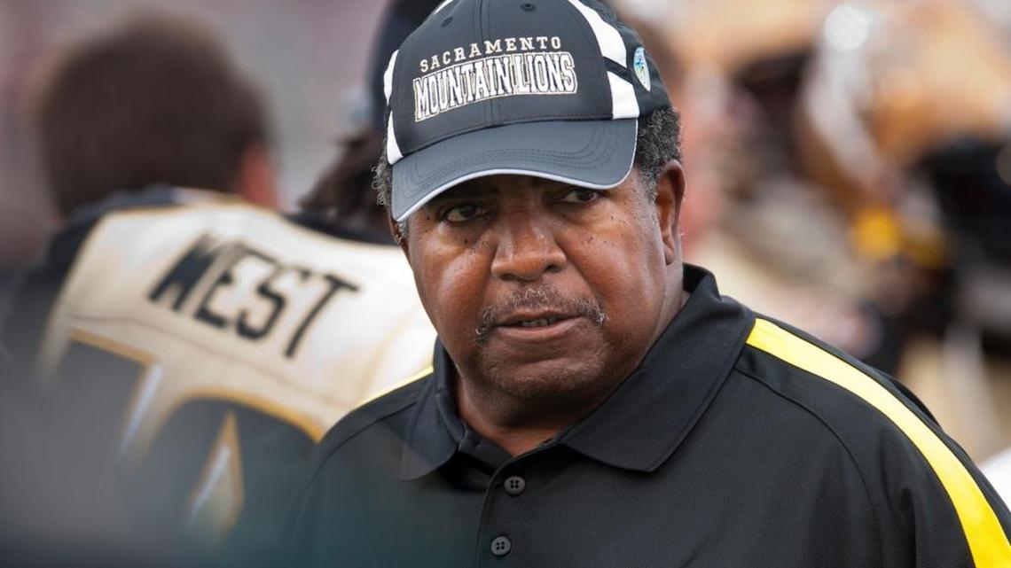 Sacramento Mountain Lions coach Dennis Green walks the sidelines in October 2011 game against Omaha, shortly before suing the league for back pay. His widow has settled the case with a former Mountain Lions owner.