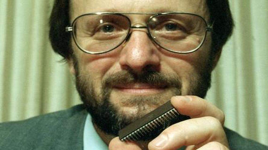 
Former Orange County inventor and entrepreneur Gilbert Hyatt, holding a microprocessor in a 1990 file photo, has been fighting with state officials for more than 20 years about his California income taxes.
