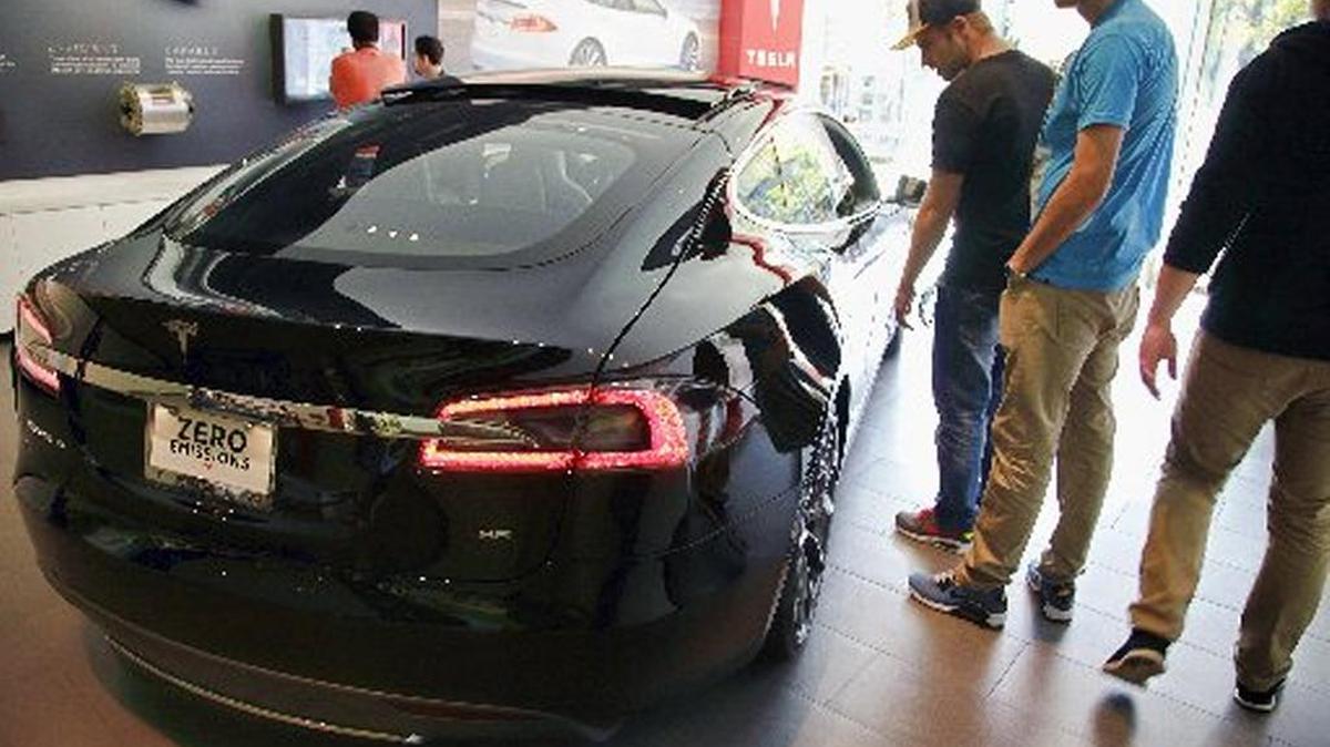 The Tesla Model S topped statewide sales of luxury/high-end sports cars in the first quarter, according to a survey announced Tuesday, May 16, 2017 by the California New Car Dealers Association. first quarter 2017 report. In this Saturday, Jan. 3, 2015 photo, people check out the Tesla model S at the Tesla showroom at the the Third Street Promenade in Santa Monica, Calif.