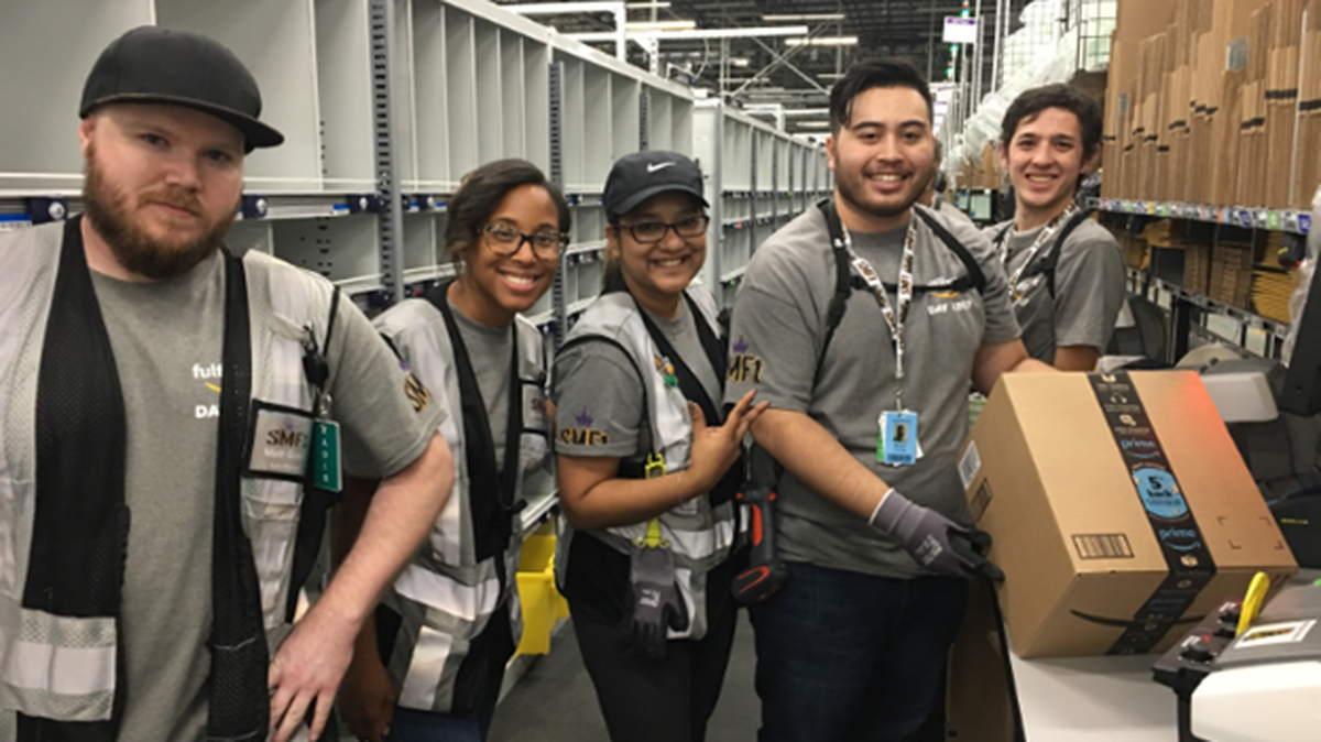 Amazon employees packed the first customer order at the Sacramento fulfillment center on Wednesday. The first order was an eight-set of Kona Coffee serve cups.