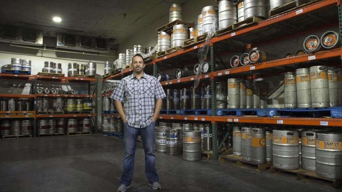Jason Musseter general manager of Mussetter Distributing in Auburn stands inside a cold storage room where he keeps draft craft beers that are distributed to clients. The once humble, two-person operation grew over the years and became a top distributor for beer-making giants that included Miller Brewing, Corona, Heineken, Sam Adams and others. However, by the turn of the millennium, the business was changing. Big-brand brewers increasingly turned to so-called “mega-distributors,” who would handle millions of cases of product on a grand scale. Mussetter’s second generation of operators shifted gears to keep the business going. Today, Mussetter Distributing specializes in handling the region’s ever-growing sector of craft beer brewers and makers of hard ciders. Jason Mussetter is the general manager of the Auburn business.