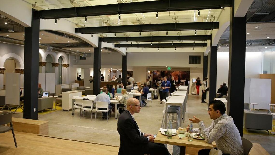 Two men have lunch at German software maker SAP's HanaHaus cafe and community workspace in Palo Alto. Technology was one of the sectors that helped drive California’s 2016 economic growth.