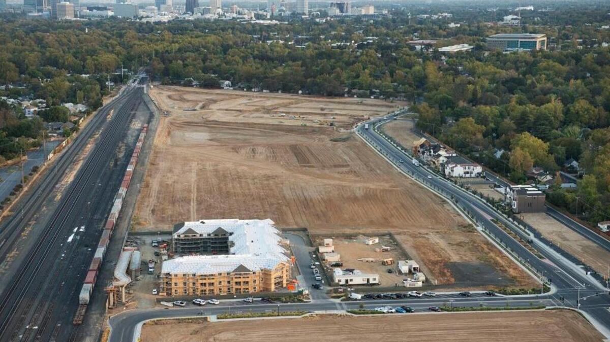 Construction at Curtis Park Village, looking toward downtown Sacramento, is seen in this aerial photo in October. The developer has submitted a plan to rename the infill development Crocker Village.