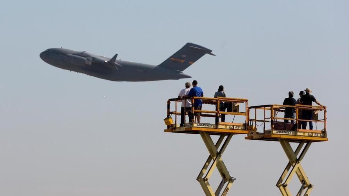 AP FILE -- Boeing Co. workers wave at a C-17 Globemaster III cargo jet built for the U.S. Air Force as it flies away at the company’s plant in Long Beach, Calif., Thursday, Sept. 12, 2013. California exports were down in October 2017, with Beacon Economics trade adviser citing “an abrupt but likely temporary fall-off in aerospace shipments” as a factor.