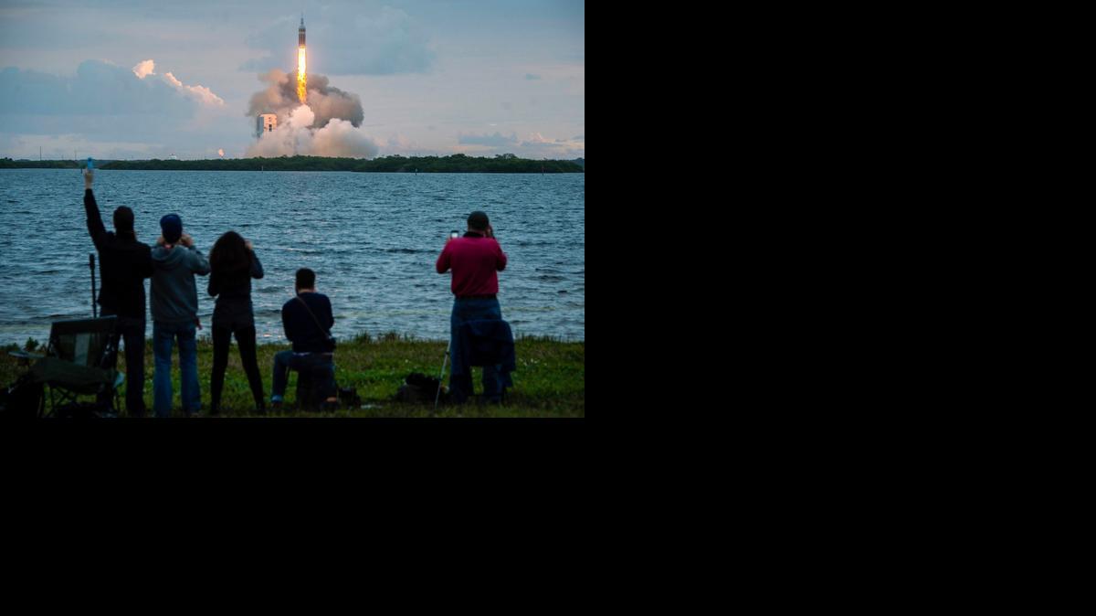 
Spectators cheer as the United Launch Alliance Delta IV heavy rocket, with NASA’s Orion spacecraft mounted atop, lifts off Friday from Cape Canaveral, Fla.
