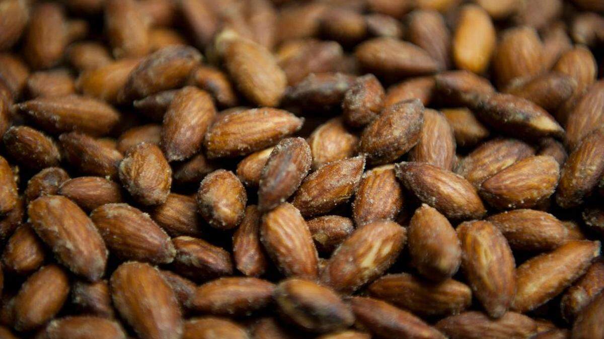 Seasoned Smoke House almonds on a conveyor belt at the Blue Diamond facility in Sacramento.
