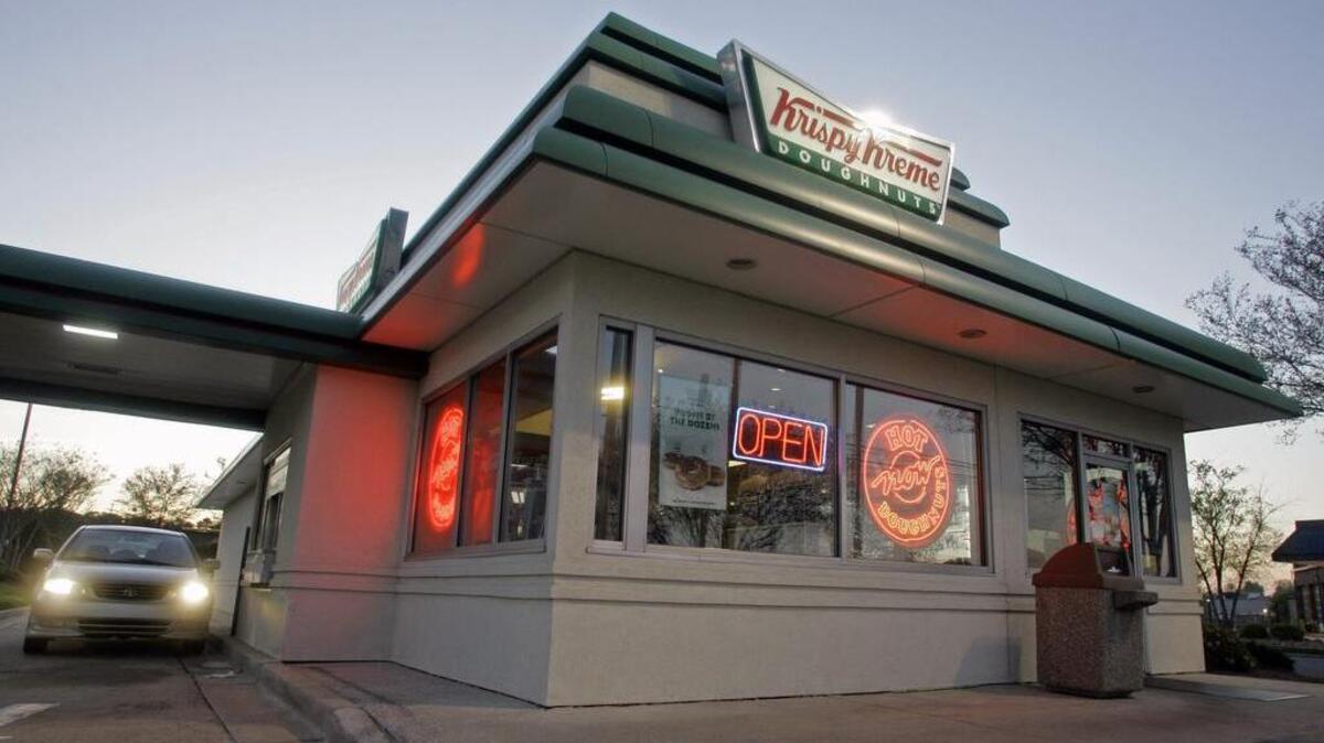 FILE - In this April 17, 2008, file photo, a customer picks up doughnuts at the drive through at a Krispy Kreme store in Matthews, N.C.