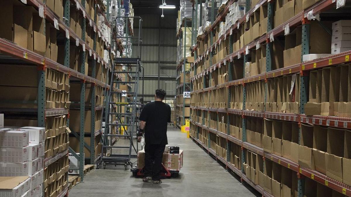 A worker gathers products at the Macy’s fulfillment center in Sacramento. Holiday hiring helped push unemployment rates into record-low territory in Sacramento and statewide in November.