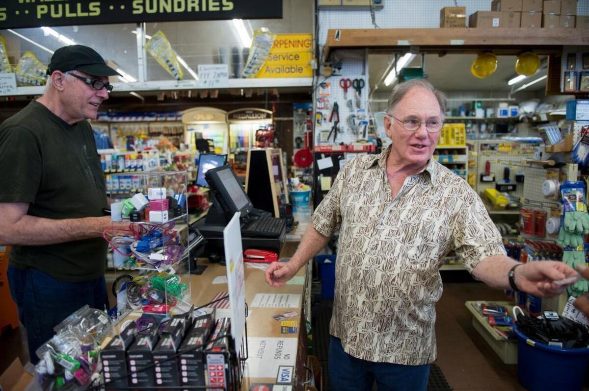 Customer Lee Anderson, left, pays Dennis Messner for new keys at Hollywood Hardware on Freeport Boulevard in 2015, just after Messner and his family sold the business.