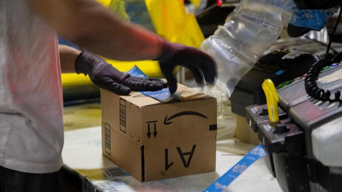 A worker tapes a box while packing items on Cyber Monday at the Amazon Fulfillment Center on Nov. 28, 2016 in San Bernardino, Calif.