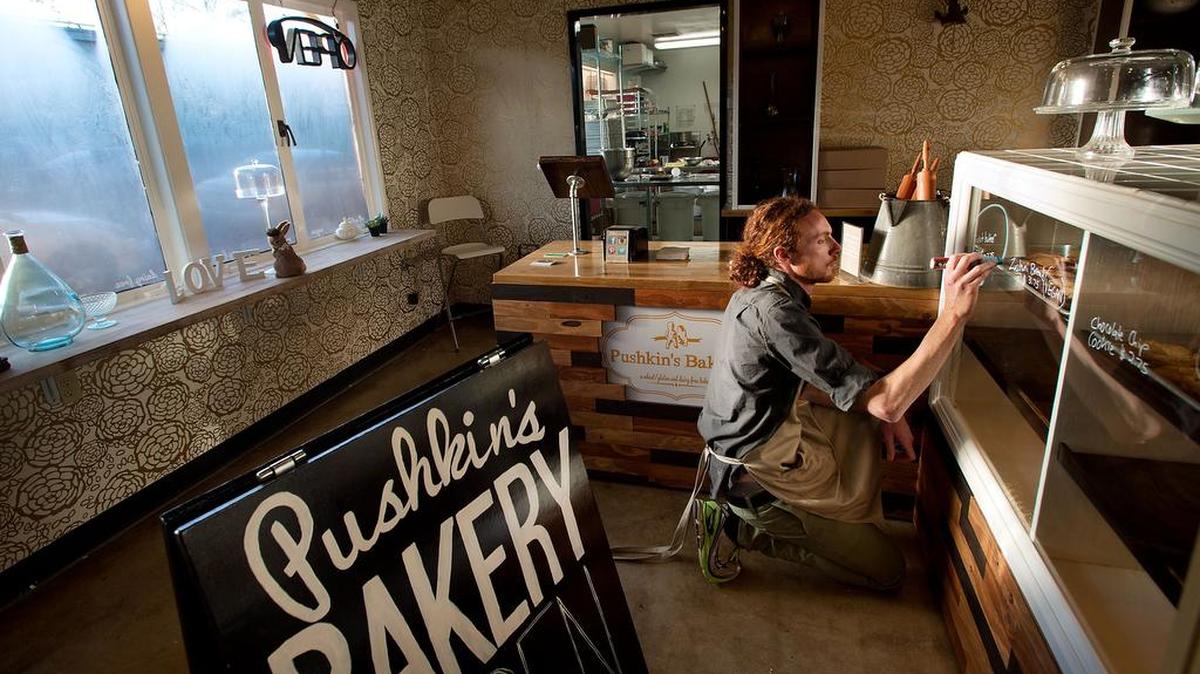 
Danny Turner marks the display windows at Pushkin’s Bakery in Sacramento. 
