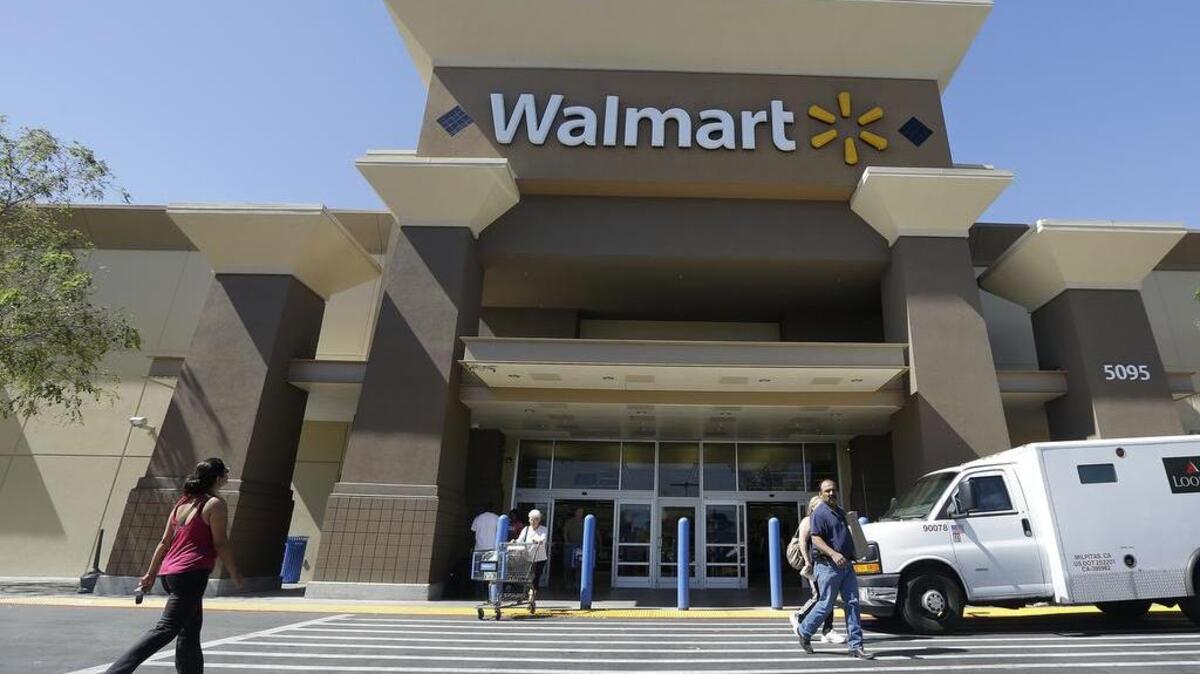 
 In this 2013 file photo, customers walk outside of a Wal-Mart store in San Jose.
