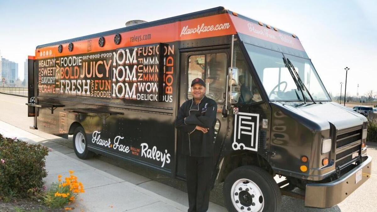 The Sacramento-based Flavor Face food truck is decked out with Raley’s logos, part of a new partnership between the West Sacramento grocery chain and local chef Brian Stansberry, seen here standing in front of his 20-foot food truck. The food truck will feature seasonal entrees that include Raley’s ingredients and products.