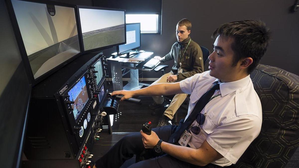 EVA Flight Training Academy trainee Isaac Wu, 28, practices on a computerized flight simulator with instructor Michael Lombart on Thursday at the new facility at Mather Airport. The academy is the first of its kind for the company in the United States.