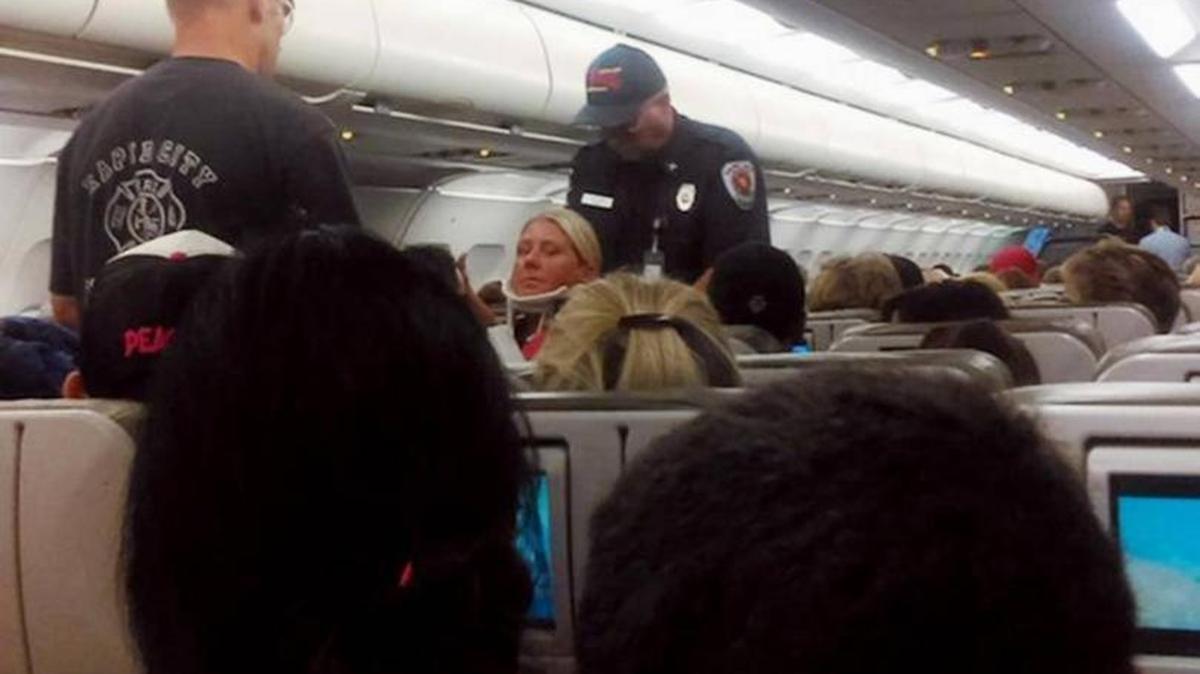 A crew member on JetBlue Flight 429 from Boston to Sacramento is placed in a neck brace and removed from the plane after the flight hit severe turbulence over South Dakota last August. The plane made an emergency landing in Rapid City and sent two dozen people to the hospital for treatment. The incident is now the subject of two federal lawsuits in Sacramento.
