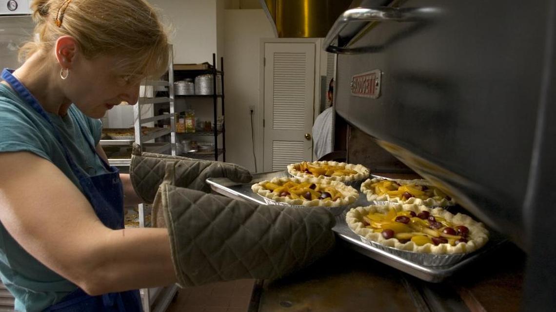 Kira O’Donnell Babach said she’s waited 10 years for the opening of The Real Pie Company at a new spot. The store’s soft opening is Sunday, April 8, 2018 at 2425 24th St. in Sacramento. She is pictured slipping a tray of fresh yellow pluot and bing cherry pies into the oven on July 18. 2007 at business’ former Sacramento location.