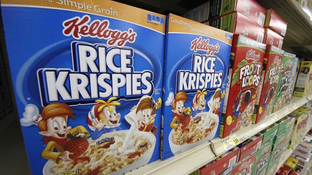 In a Wednesday, July 18, 2012, file photo, Kellogg’s cereals are on display at a Pittsburgh grocery market. Kellogg is closing distribution centers around the nation, laying off more than 1,000 workers. The company is following through on a prior decision to shift to a warehouse system. It has been cutting costs as sales decline amid changing consumer trends. (AP Photo/Gene J. Puskar, File)