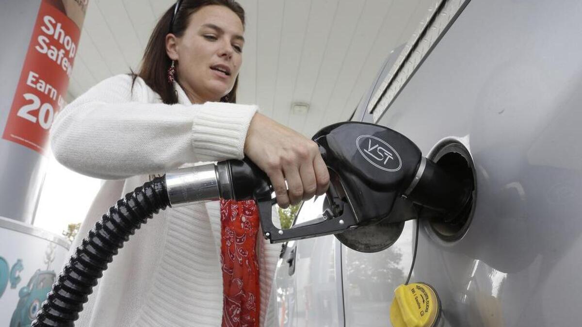 
Lydia Holland fills up at a gas station in Sacramento, Calif. The United States and China can look to California as an example of the costs and challenges of fighting global warming, since the state has imposed some of the world’s toughest air quality standards as it moves to lower emissions. 
