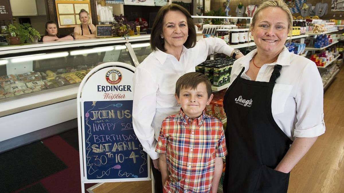 The German Deli owners Vivian Smith, left, daughter Allyson Smith, and her son J.T. Guill, 6, stand inside their store with employees Katie Muir and Diana Fine, behind the counter, on Tuesday April 19, 2016, in Sacramento. The deli is marking its 50th year in business this year.