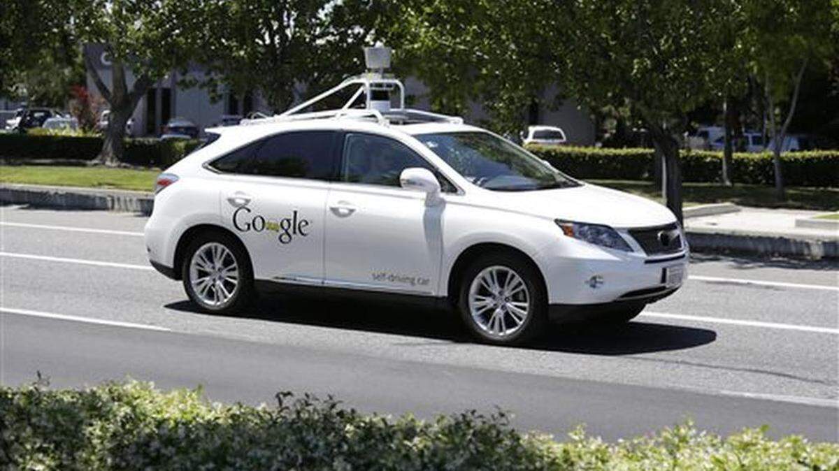 FILE - In this May 13, 2014 file photo, a Google self-driving car goes on a test drive near the Computer History Museum in Mountain View, Calif. California unveiled precedent-setting draft rules Wednesday that would slow the public's access to self-driving cars of the future until regulators are confident the technology is safe.