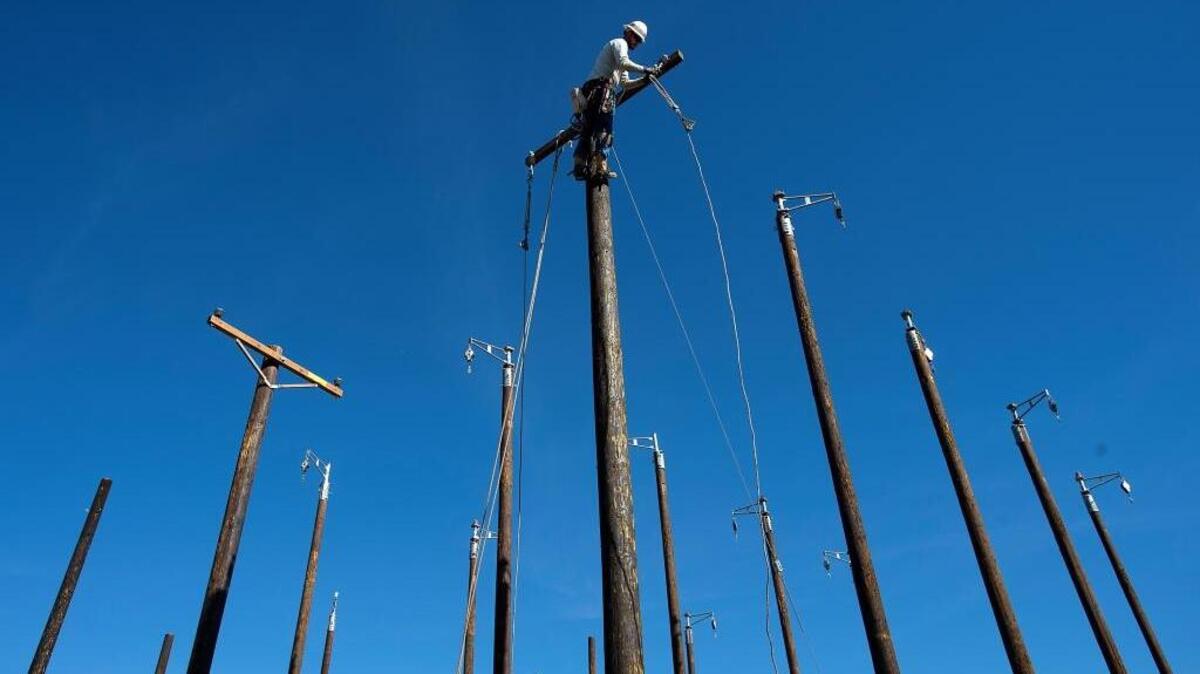 Apprentice lineman Darin Floyd demonstrates “sagging” an electrical power line at the SMUD Power Academy in Sacramento on Friday, Nov. 6, 2015.