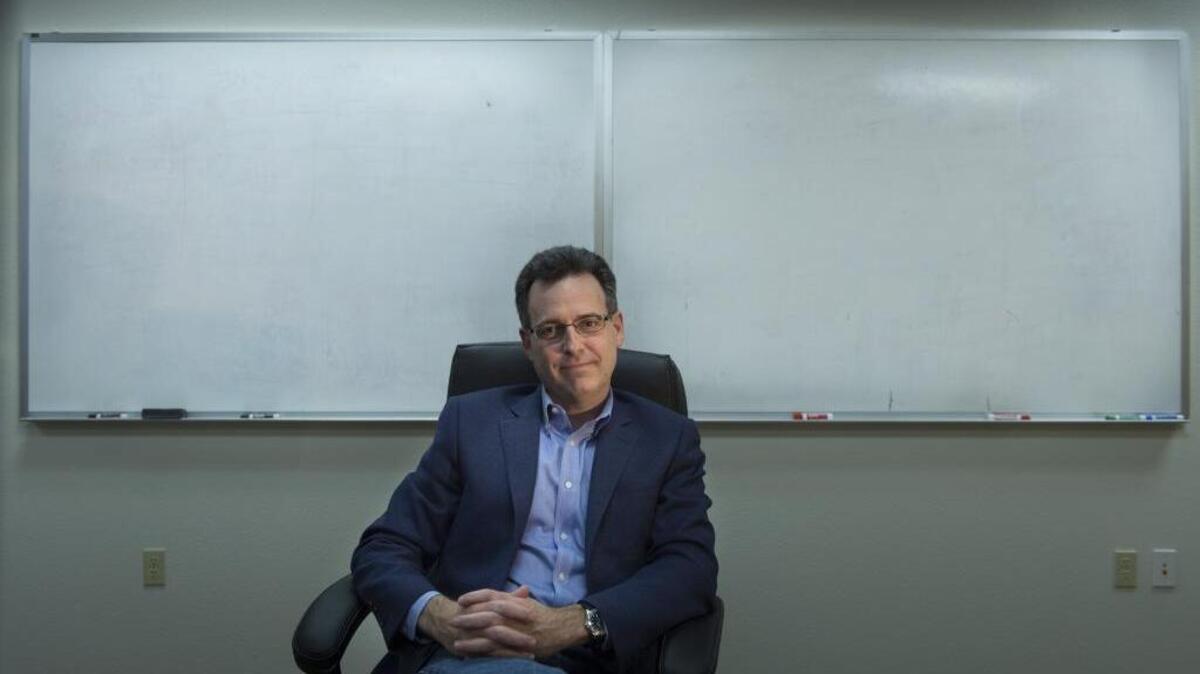 FILE -- Jon Coss CEO and co-founder of Gold River-based Pondera Solutions, a firm focused on fraud-detection software for government agencies, sits in front of recently erased white board in the company's conference room in Gold River, Calif., on Jan. 11, 2016.