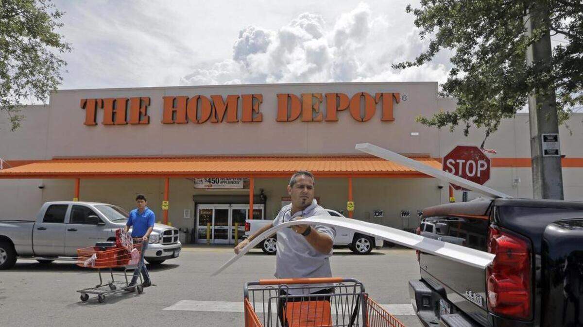 FILE - In this July 13, 2015, file photo, Vicente Aguiar loads garage door trims into his pickup truck outside a Home Depot in Hialeah, Fla. Home Depot reports financial results Tuesday, Feb. 20, 2018.