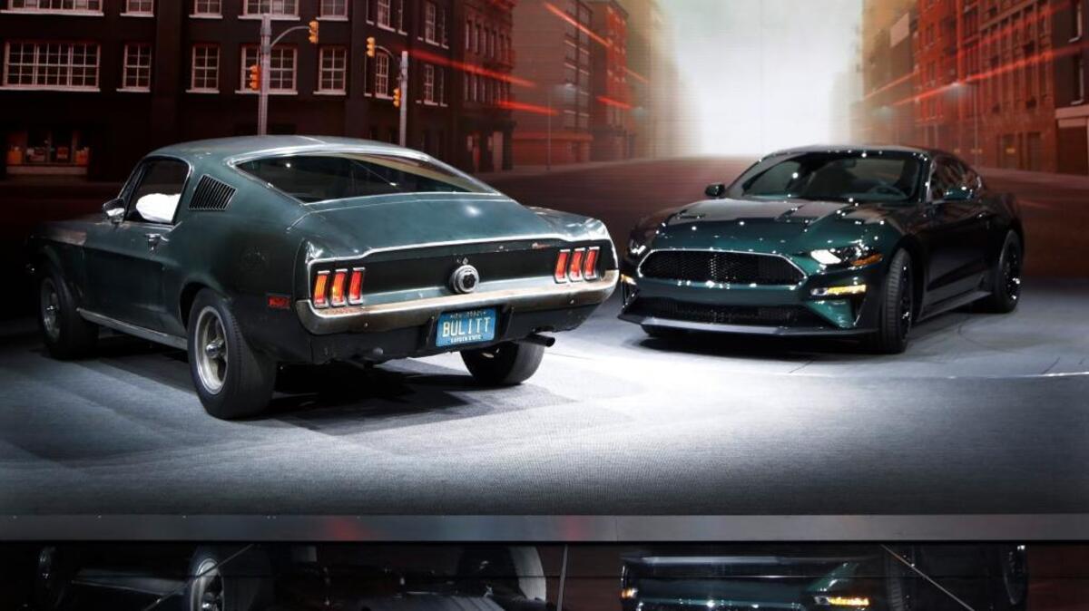 Celebrating the 50th anniversary of iconic movie “Bullitt” and its iconic San Francisco car chase, Ford introduces the new 2019 Mustang Bullitt, right, next one of the original cars used in the film Sunday at the North American International Auto Show in Detroit.