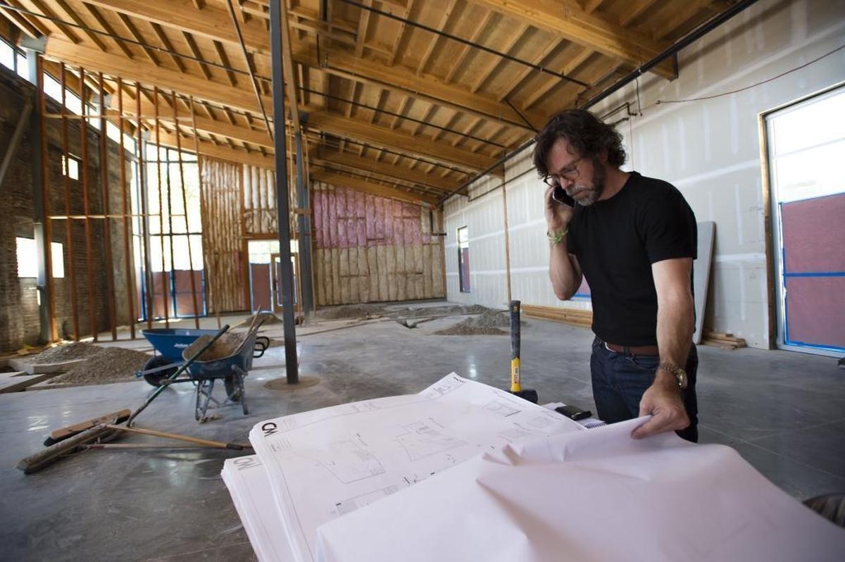 Michael Hargis looks over the plans for his new restaurant, Beast + Bounty, at the Ice Blocks on Monday July 24, 2017 in Sacramento.