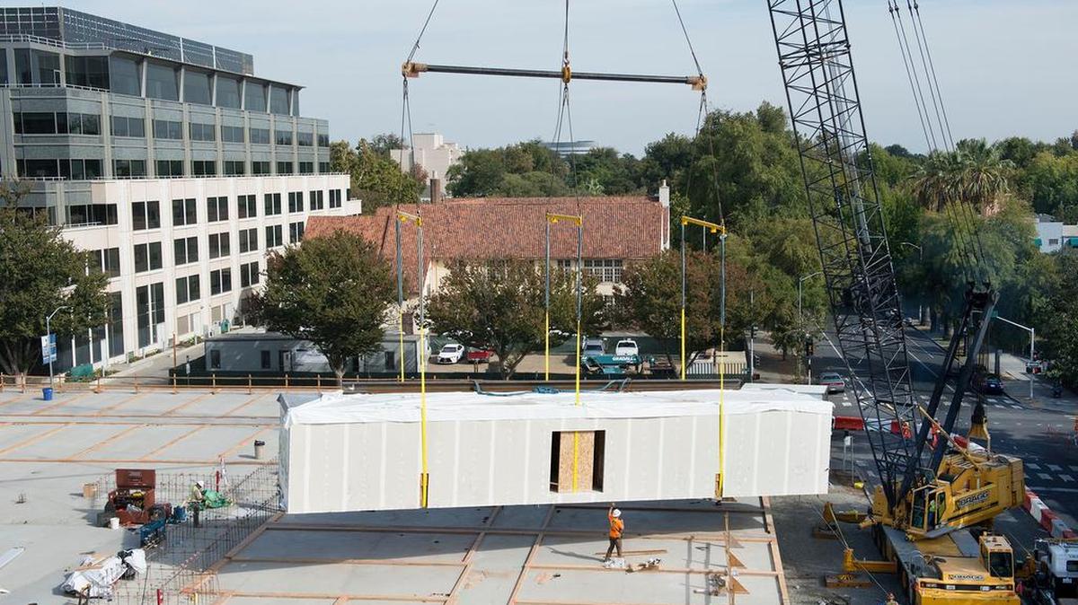 
Workers place a modular piece of the Eviva Midtown apartments. One lane of 16th Street was closed for the work and will be in the coming weeks. 


