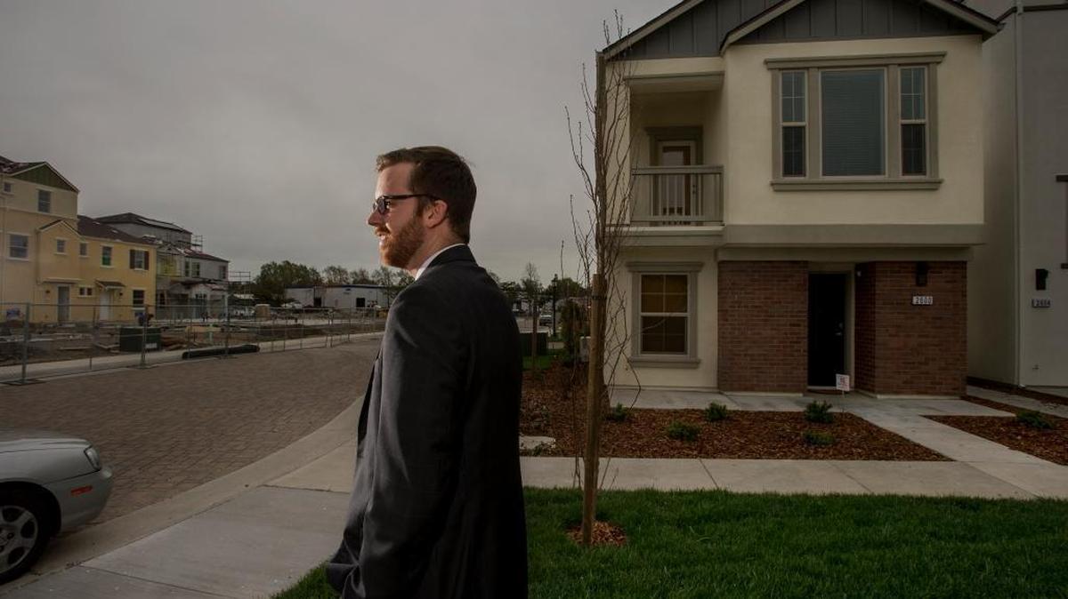Scott Lewis, 25, bought a detached, 900-square-foot condominium at The Mill at Broadway. The Mill sits near a freeway and industrial companies, but it is walking distance to downtown Sacramento jobs and the new sports and entertainment arena, which is attracting new first-time buyers like Lewis.