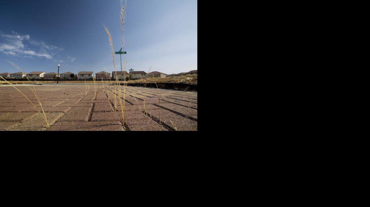 
Weeds grow on an unfinished lot in the Natomas area of Sacramento last May. Federal flood rules have prevented construction in the region since December 2008. That could change soon if a building moratorium is lifted. 
