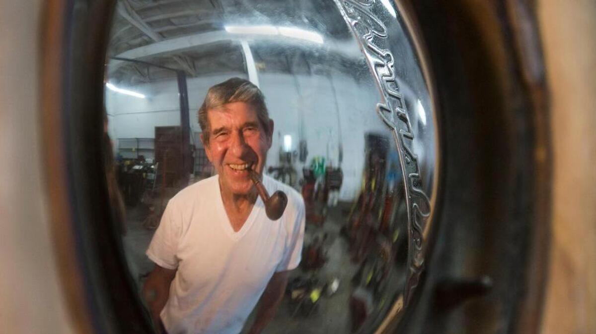 
Ed Quint, with his pipe, is reflected in the hubcap of a 1948 Chrysler New Yorker Highlander at Porter-Sprague, a Sacramento-based auto shop that started business in 1917. The 85-year-old Quint has decided to end his reign as shop owner and finally retire.

