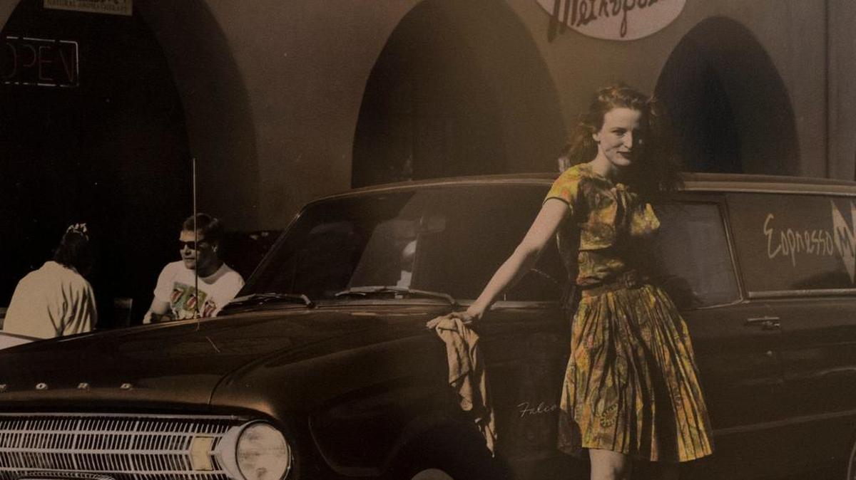 A photograph shot in 1991 of Joan Riordan still hangs on the walls of Espresso Metropolitan. In it, she wore the same dress that she donned Tuesday for the top photo.