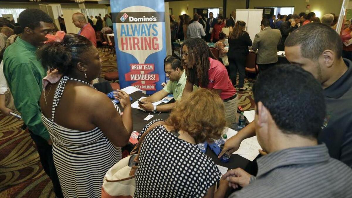 
Job seekers listen as Kaysara Mandry, center, talks about job opportunities at the Domino's booth during a job fair in Miami Lakes, Fla. Employers added a meager 142,000 jobs in September 2015, the government said Friday, Oct. 2. And the average job gain for each of the past three months, 167,000 is well below the 231,000 average for the previous three.
