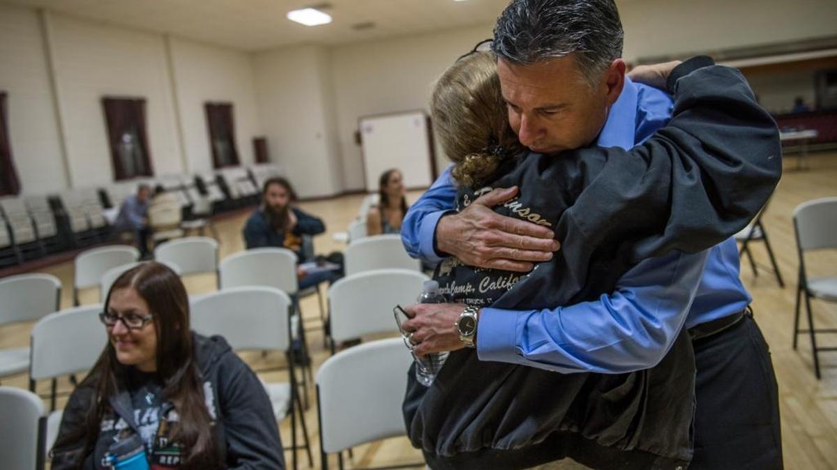 Sacramento lawyer John Airola, raised in Calaveras County, embraces fire victim Kitty Smith, 54, who was his third-grade classmate, on Tuesday at the San Andreas town hall, in San Andreas. Lawsuits are stacking up against PG&E for allegedly starting the Butte fire. At least four lawsuits filed in recent weeks allege the utility giant didn’t properly maintain its power lines and that a transmission line touching a tree sparked the September fire that killed two and destroyed 475 homes.