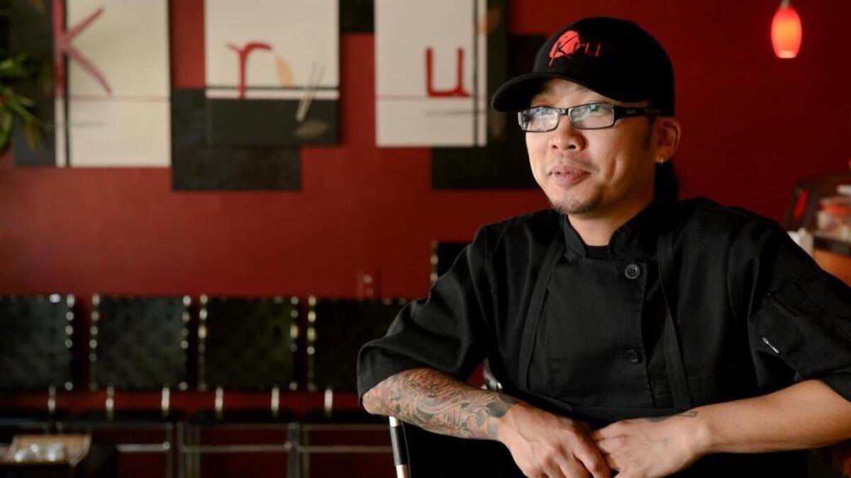 Bill Ngo sits at the sushi bar at his restaurant Kru on July 11, 2013 in Sacramento, Calif.