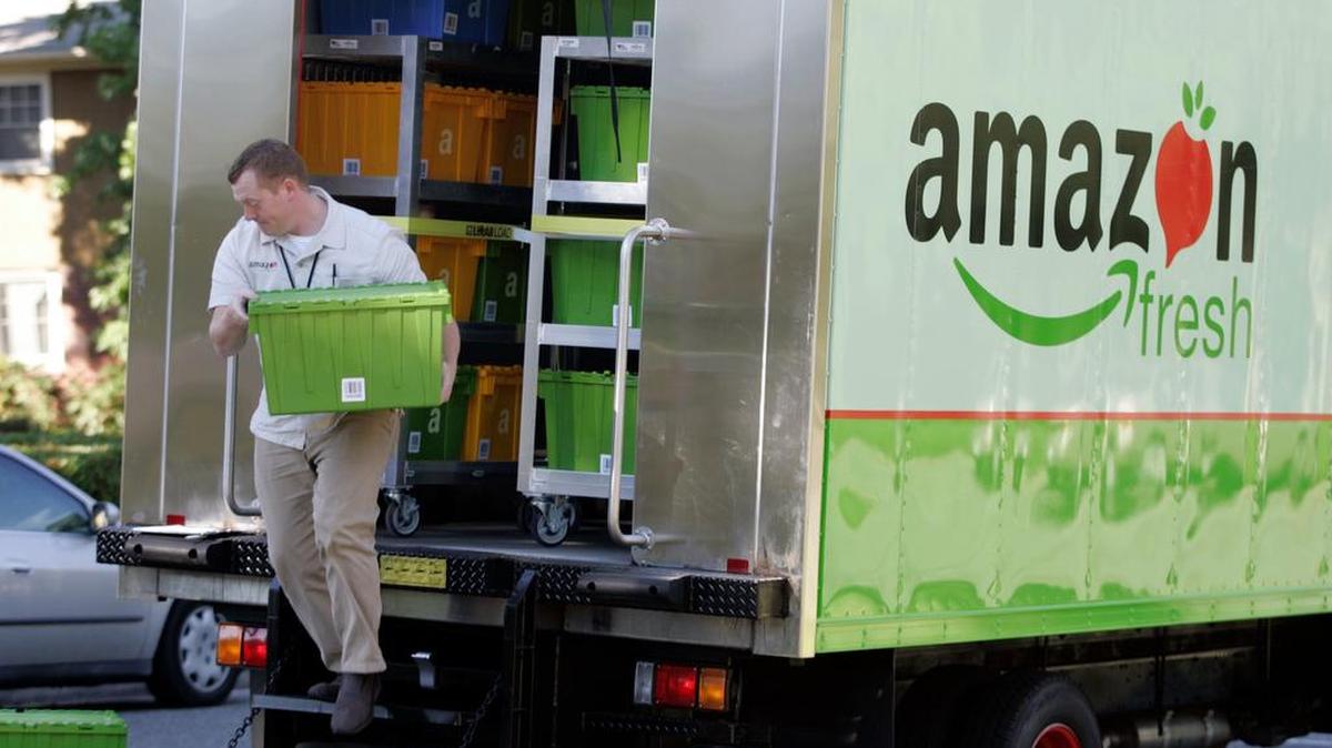 Amazon Fresh deliveryman Tim Wilkie prepares a grocery order for delivery to a residence on Mercer Island, Wash.