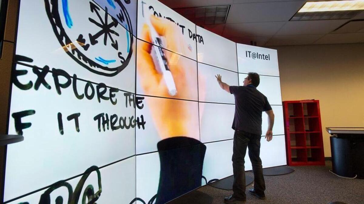 Tech Researcher Justin Lipman interacts with a large monitor array at the Intel facility in Folsom on Friday, March 21, 2014.