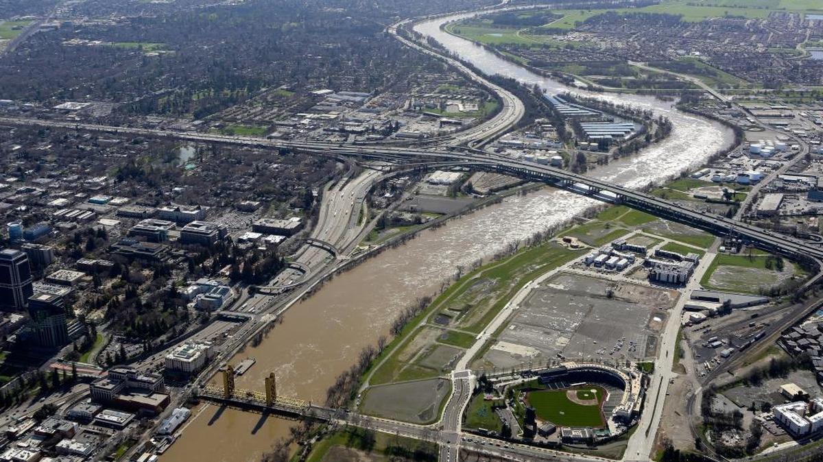 The muddy Sacramento River flows under the Tower Bridge and past Old Sacramento on sunday, February 12, 2017.