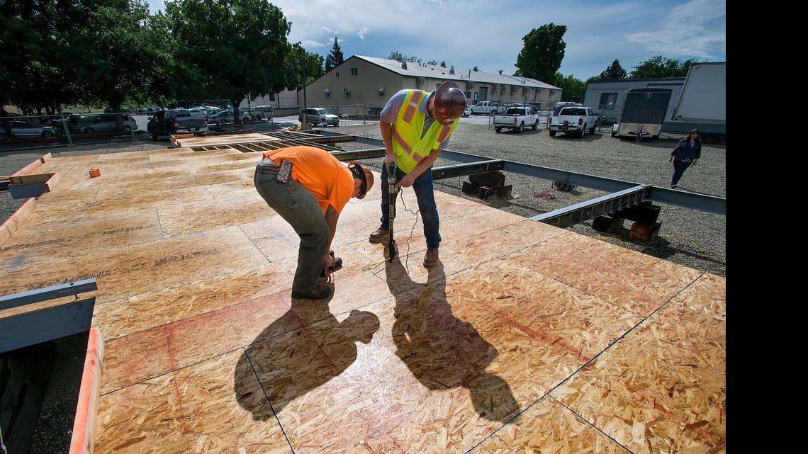 
CSUS construction management student Nick Hansen, left, and Simpson Strong-Tie representative Mike Couch fasten floors to a steel frame at Sac State on Thursday. CSUS students are building a solar house as part of the U. S. Department of Energy Solar Decathlon. Sixteen universities are participating in the decathlon, which is held every two years.
