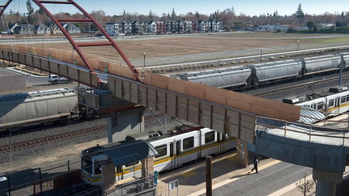 A view of Curtis Park Village showing the new pedestrian bridge connecting Curtis Park and Sacramento City College and the row of townhouses already constructed on Wednesday, Dec. 16, 2015.