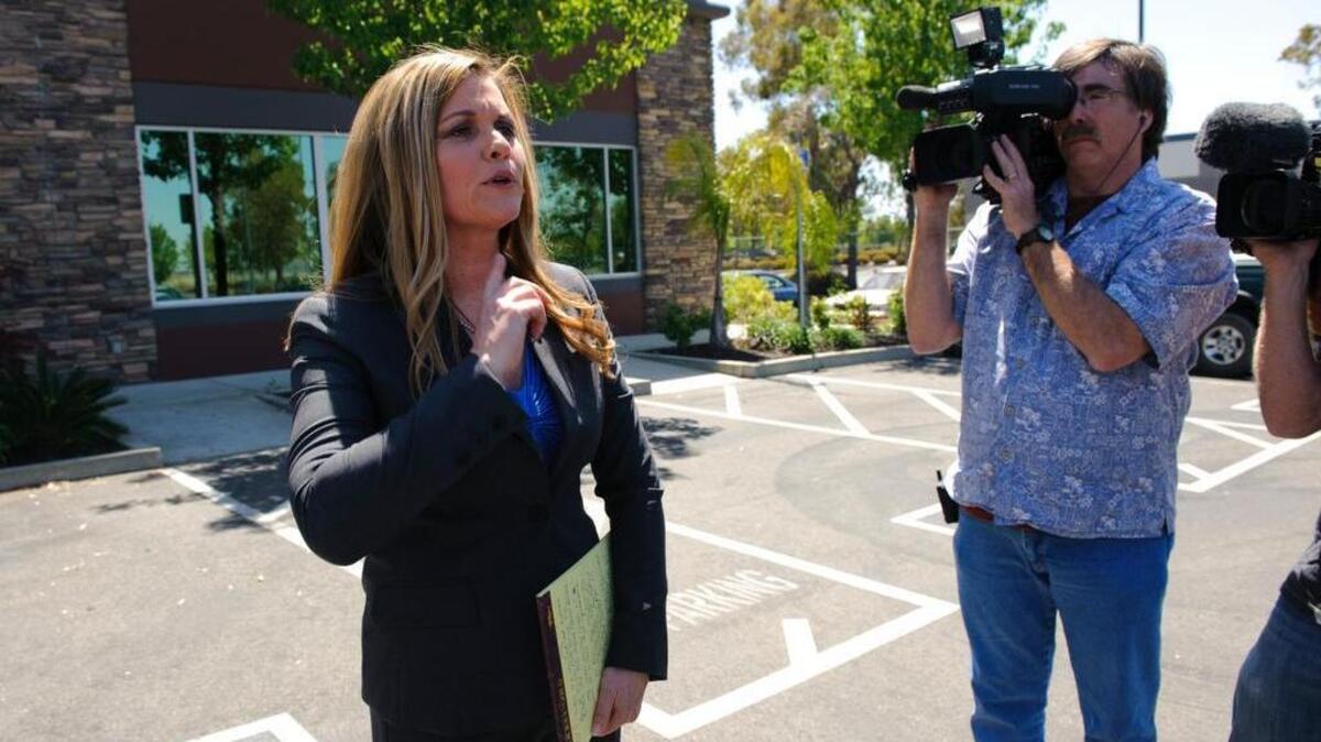 
Roni Lynn Deutch addresses reporters in a defiant news conference in front of her shuttered North Highlands office in May 2011. The state attorney general had levied contempt of court charges accusing her of shredding millions of pages of documents and failing to pay clients refunds in violation of a court order. Deutch closed her law firm a month after the state obtained a court order freezing her assets.
