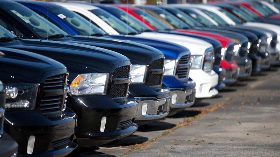Dodge Ram pickup trucks sit on a lot at a dealership in Georgia. California officials announced a $500 million settlement with Fiat Chrysler over the use of rogue software to conceal air pollution on Dodge Rams and Jeep Grand Cherokee diesel models.