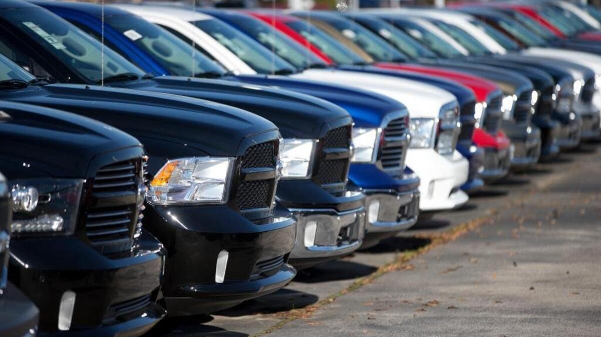 Dodge Ram pickup trucks sit on a lot at a dealership in Georgia. Federal and California officials have accused Fiat Chrysler of using rogue software to conceal air pollution emissions from 104,000 diesel vehicles.