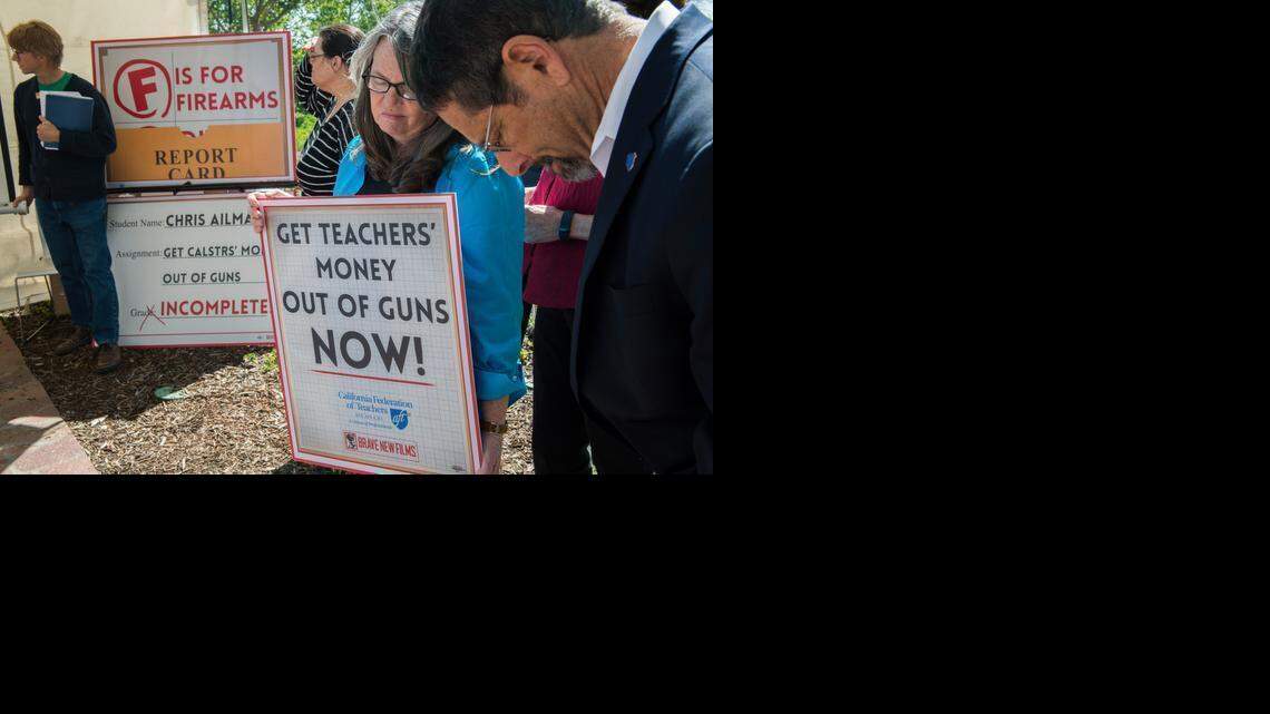 
Members of the California Federation of Teachers participate in a moment of silence Thursday as they protest outside a board meeting at CalSTRS headquarters in West Sacramento over continued firearms investments. From left are Bill Miller, Linda Sneed, Joanna Valentine and Fred Glass.
