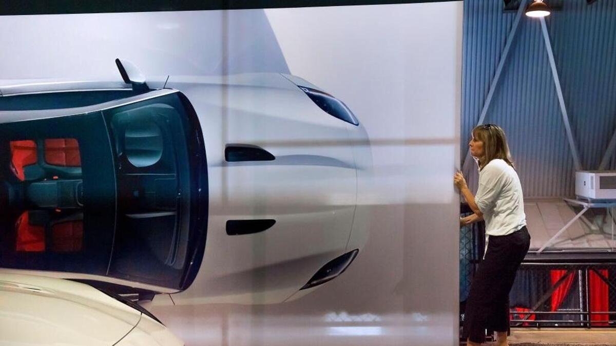 
Nikki Pane pulls a display panel into place in preparation for this weekend's Sacramento International Auto Show at Cal Expo in Sacramento on Thursday, Oct. 15, 2015. The Sacramento International Auto Show, featuring many 2016 auto models from nearly 40 domestic and foreign automakers, will kick off its three-day run on Friday.
