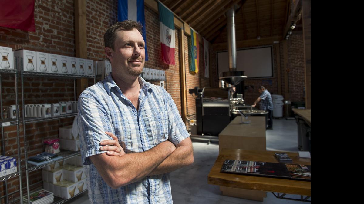 
CEO Thaleon Tremain stands in the offices of the Pachamama Coffee Cooperative as Ed Alagozian, director of coffee, roasts Guatemala coffee beans this week in Sacramento.
