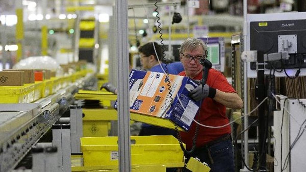 Amazon was among online retailers that experienced brisk business over the 2016 holiday shopping season. In this file photo, Mark Oldenburg processes outgoing orders, Monday, Nov. 30, 2015, at Amazon.com’s fulfillment center in DuPont, Wash.